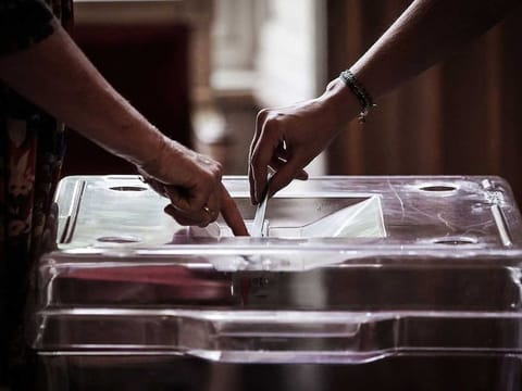 A voter casts ballot during the second round of France's crunch legislative elections at a polling station in Bordeaux, south-western France on July 7, 2024. 