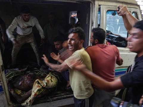 People react before moving the charred body of a Palestinian killed in an Israeli strike into Nasser hospital in Khan Yunis in the southern Gaza Strip on July 9, 2024. 