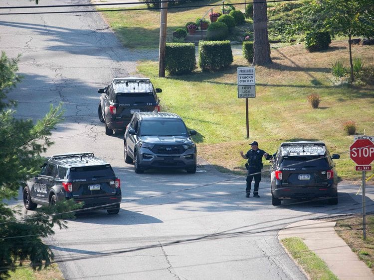Local police block off roads surrounding the home of the suspected shooter of Trump, as the FBI carries out an investigation, in Bethel Park, Pennsylvania, on July 14, 2024.  The alleged shooter was killed by law enforcement officials after he fired an AR-15-type semiautomatic rifle, killing one spectator and wounding others.