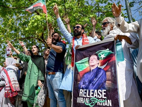 Supporters of Pakistan's former prime minister and Pakistan Tehreek-e-Insaaf (PTI) party leader Imran Khan, celebrate after a court verdict overturned his illegal marriage conviction, outside the court building in Islamabad on July 13, 2024.  