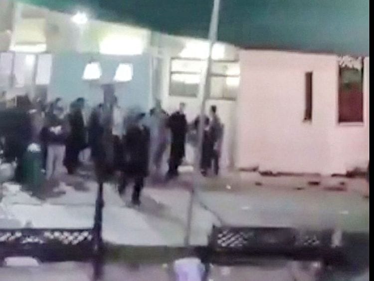 This image grab from a UGC video taken on July 16, 2024 shows people fleeing the scene of a shooting at a mosque in the Al Wadi Al Kabir area in the east of Oman's capital Muscat.  