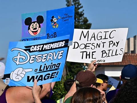 Disney cast members rally outside the main entrance of Disneyland Resort in Anaheim, California.