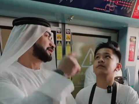 An RTA official engages with Albert Franco Agudera, 11, on Dubai Metro.