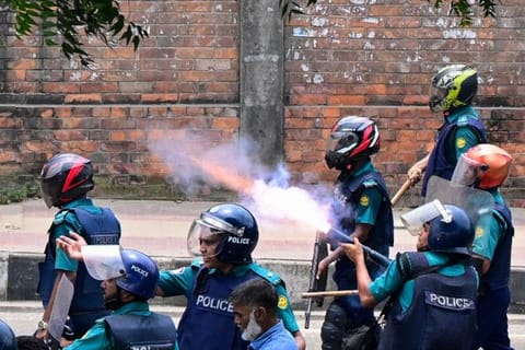Bangladesh police fire tear shells to disperse anti-quota protesters during a clash in Dhaka on July 18, 2024.  