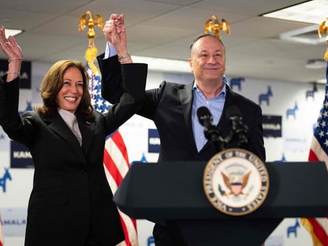 US Vice President and Democratic presidential candidate Kamala Harris and Second Gentleman Doug Emhoff acknowledge the crowd before speaking at her campaign headquarters in Wilmington, Delaware, on July 22, 2024.  