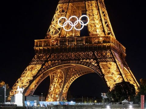 The Olympic rings on an illuminated Eiffel Tower, ahead of the Olympic Games in Paris, France, on July 23, 2024. River Seine will host the opening ceremony on July 26, staged for the first time on boats and barges floating downstream through the city.  