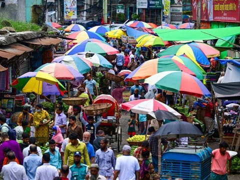 People shop at a market as the curfew is relaxed after the anti-quota protests in Dhaka on July 25, 2024.  