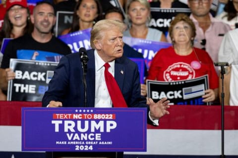 Former US President and 2024 Republican presidential candidate Donald Trump, a bandage on his ear after being injured during an assassination attempt, speaks during a campaign rally at the Bojangles Coliseum in Charlotte, North Carolina, on July 24, 2024.  