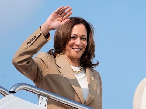 US Vice President and Democratic presidential candidate Kamala Harris waves while boarding Air Force Two from Westfield-Barnes Regional Airport in Westfield, Massachusetts, on July 27, 2024, as she returns to Washington, DC, after attending a campaign fundraising event. 