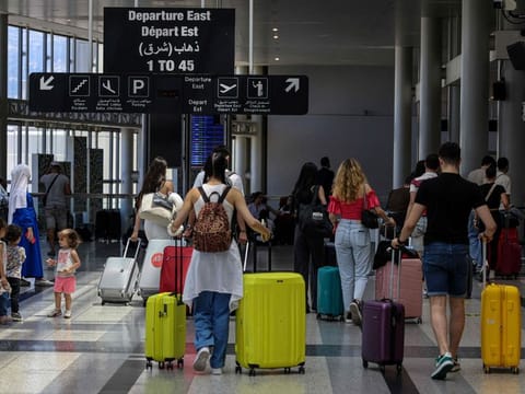 Passengers depart Rafik Hariri International Airport as many flights are delayed or cancelled in Beirut on July 29, 2024.  