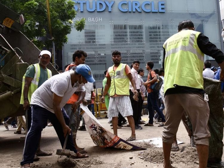 Delhi Municipal Corporation (MCD) workers were present outside the Rau’s IAS Study Centre in Old Rajinder Nagar, New Delhi, on July 28, 2024, amid a student protest following the deaths of three civil service aspirants who drowned in the coaching centre's basement due to flooding.