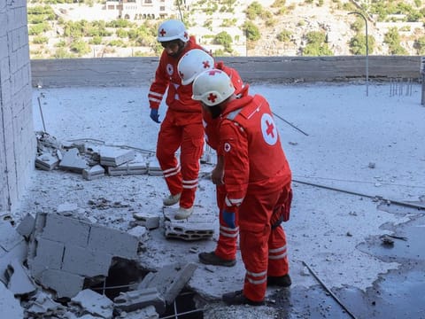 Members of the Lebanese Red Cross inspect the damage following Israeli bombardment in the southern border village of Shebaa on July 29, 2024.  