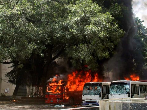Buses on fire at the Bangabandhu Sheikh Mujib Medical University premises after a clash between students and government supporters in Dhaka on August 4, 2024.