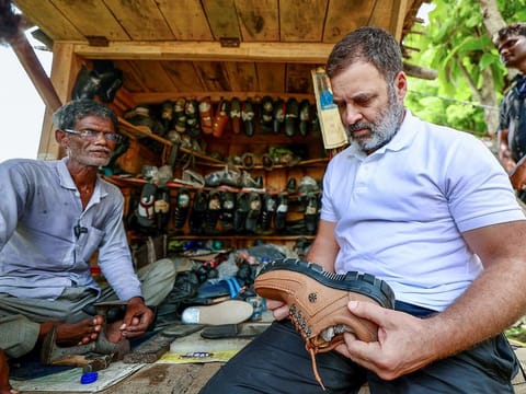 Congress leader Rahul Gandhi meets with a skilled cobbler in India