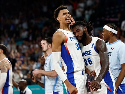 France's Victor Wembanyama and Mathias Lessort celebrate in the men's quarter-final basketball match against Canada during the Paris 2024 Olympic Games at the Bercy Arena on Tuesday.
