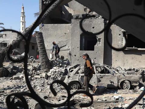 A Palestinian man walks past destruction in Deir Al Balah in Gaza, on August 7, 2024, following Israeli bombardment 