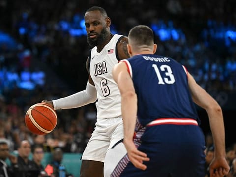 USA's LeBron James challenges Serbia's Ognjen Dobric in the men's semifinal basketball match between USA and Serbia.
