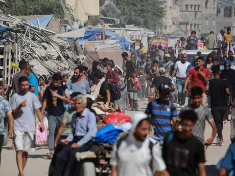 Displaced Palestinians leave an area in east Khan Yunis towards the west, after the Israeli army issued a new evacuation order for parts of the city, in the southern Gaza Strip. 