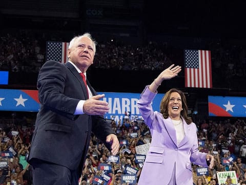 US Vice President and Democratic presidential candidate Kamala Harris (R) and Minnesota Governor and vice presidential candidate Tim Walz gesture during a campaign rally at the Thomas and Mack Center, University of Nevada in Las Vegas, Nevada, on August 10, 2024. 