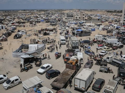 Displaced Palestinians flee following evacuation orders from the Israeli army to leave the Hamad district of Khan Younis, southern Gaza, on August 11, 2024.  