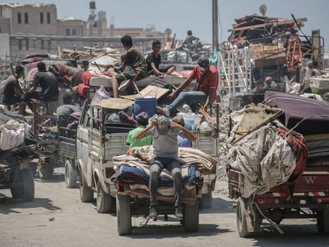 Displaced Palestinians flee following evacuation orders from the Israeli army to leave the Hamad district of Khan Younis, southern Gaza, on August 11, 2024.  