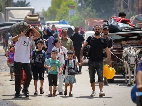 Palestinians flee with their belongings Deir El Balah in the central Gaza Strip on August 16, 2024, amid the ongoing conflict between Israel and the Hamas militant group. 