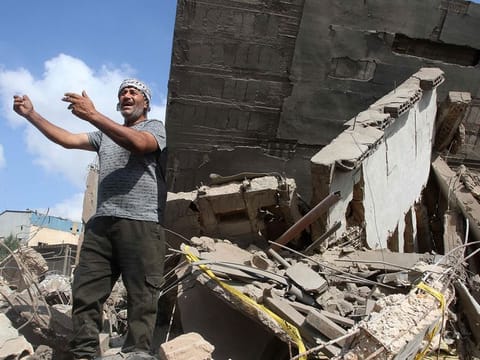 A man inspects the damage to a building after an Israeli strike in the southern town of Kfour, in the Nabatiyeh district, on August 17, 2024, amid the ongoing cross-border clashes between Israeli troops and Hezbollah fighters. 
