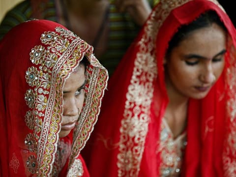 In this photograph taken on August 3, 2024 Shamila (left) and Salma Zameer, monsoon brides who were married underage in Khan Muhammad Mallah village, Dadu district in Sindh province.  