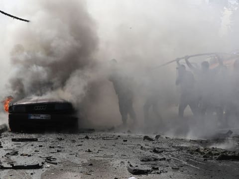 Lebanese firefighters put out a fire in a car after an Israeli strike in the southern city of Sidon on August 21, 2024.  