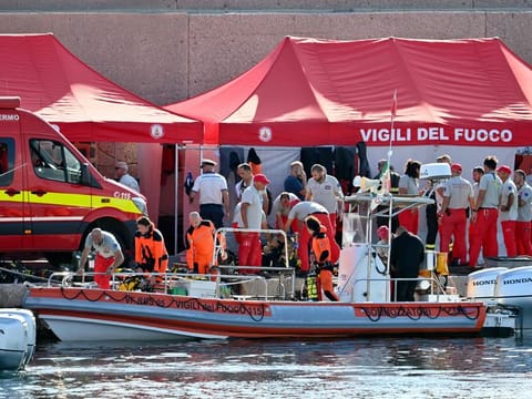 Divers of the Vigili del Fuoco, the Italian Corps. of Firefighters, get ready in Porticello near Palermo, on August 21, 2024 two days after the British-flagged luxury yacht Bayesian sank. Rescuers with divers and an underwater drone search for six people believed trapped when the boat sank. 