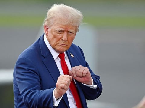 Former US President and Republican presidential candidate Donald Trump gestures during a campaign rally at the North Carolina Aviation Museum & Hall of Fame in Asheboro, North Carolina, August 21, 2024. 