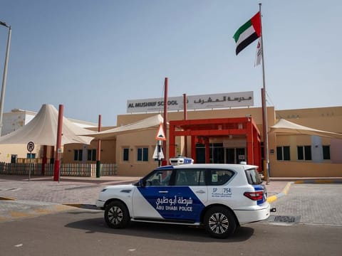An Abu Dhabi Police patrol ensuring safety and security in front of a school ahead of the new term 