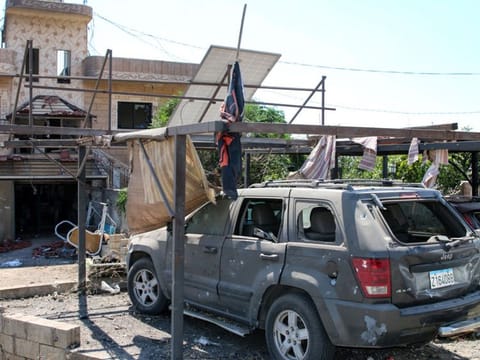 A damaged car is parked outside a building hit by an Israeli strike a day earlier, in the village of Wadi Sheet near the city of Baalbek in eastern Lebanon on August 21, 2024.  