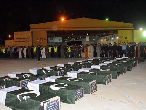 Government officials offer funeral prayers for the victims of bus accident who were killed when they were travelling to Iraq via Iran, after bodies arrived at the Pakistan's air base in Jacobabad, in Sindh province on August 23, 2024. 