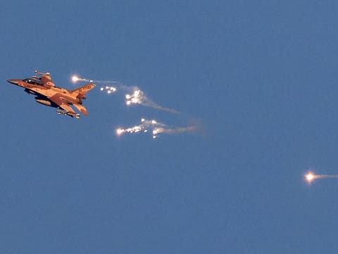 This photo taken from a position in northern Israel shows an Israeli Air Force fighter jet firing flares as it flies to intercept a hostile aircraft that launched from Lebanon over the border area with south Lebanon on August 25, 2024.