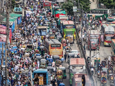 Commuters ride along a street in Old Dhaka. [Illustrative image] 