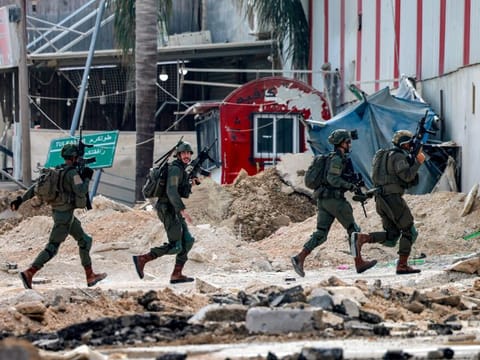 Israeli soldiers take position during an army operation in Tulkarem in the north of the occupied West Bank on August 29, 2024.  
