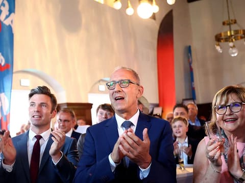 Joerg Urban (C), top candidate of the far-right Alternative for Germany party (AfD) reacts after the first exit polls for the Saxony state elections, in Dresden, eastern Germany, on September 1, 2024.  