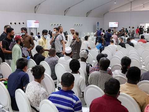 Amnesty applicants at a GDRFA counter in Al Awir.