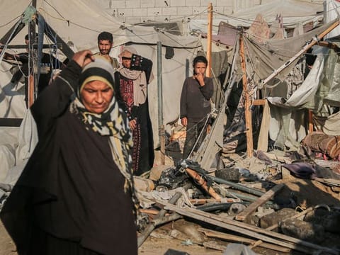 Palestinians amongst debris in a tented area following Israeli shelling near the Al-Aqsa Martyrs Hospital in Deir al-Balah, Gaza, on Thursday, Sept. 5, 2024. 