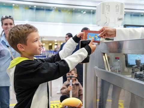 A young passenger receiving a free Nol card at Dubai airport on MOnday.