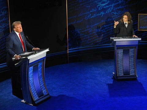 US Vice President and Democratic presidential candidate Kamala Harris speaks as former US President and Republican presidential candidate Donald Trump listens during a presidential debate at the National Constitution Center in Philadelphia, Pennsylvania, on September 10, 2024. 