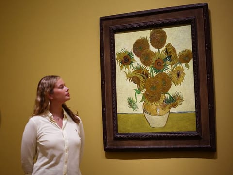 Visitors look at a painting made by late Dutch artist Vincent Van Gogh "Sunflowers" 1888, during a press preview for "Van Gogh: Poets and Lovers" exhibition at the National Gallery, in London, on September 9, 2024. 