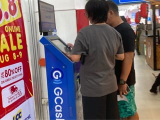 People using a GCash kiosk in the Philippines. 