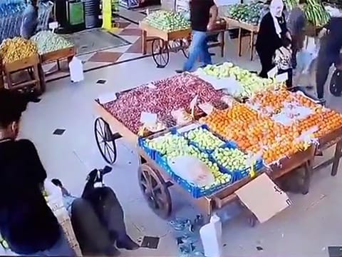 An image grab taken from a UGC video posted on social media on September 17, 2024, appears to show an explosion and a man falling to the floor (L) at an indoor vegetable market in Beirut, as hundreds of pagers used by Hezbollah members exploded across Lebanon, killing at least 12 people and wounding around 3,000 in blasts the Iran-backed militant group blamed on Israel. 