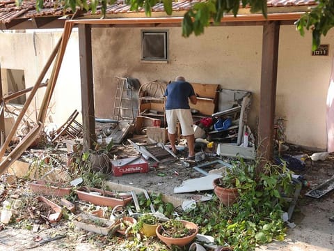 A man inspects the damage at the site of a rocket attack, fired from Lebanon, in Kibbutz Saar, north of Nahariya on September 25, 2024. 