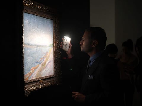 A visitor looks closely at a work on display by Vincent van Gogh at the official unveiling of Christie’s new Asia Pacific headquarters at the Henderson Centre in Hong Kong on September 20, 2024. 