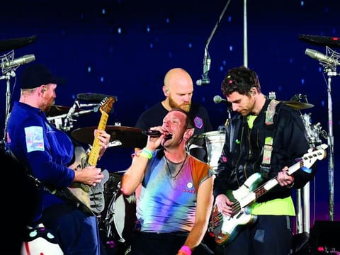 Jonny Buckland, Chris Martin, Will Champion and Guy Berryman of Coldplay (L-R) perform onstage at Rose Bowl Stadium in September 2023 in Pasadena, California. 