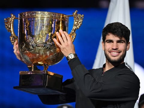 Spains Carlos Alcaraz celebrates with the trophy after winning the mens singles final against Italys Jannik Sinner at the China Open tennis tournament in Beijing on Wednesday.