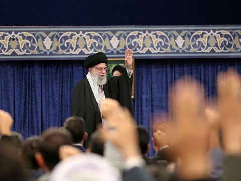 This handout picture provided by the office of Iran's Supreme Leader Ayatollah Ali Khamenei shows him waving to the crowd during a gathering of Iranian top scientific talents in Tehran on October 2, 2024. 